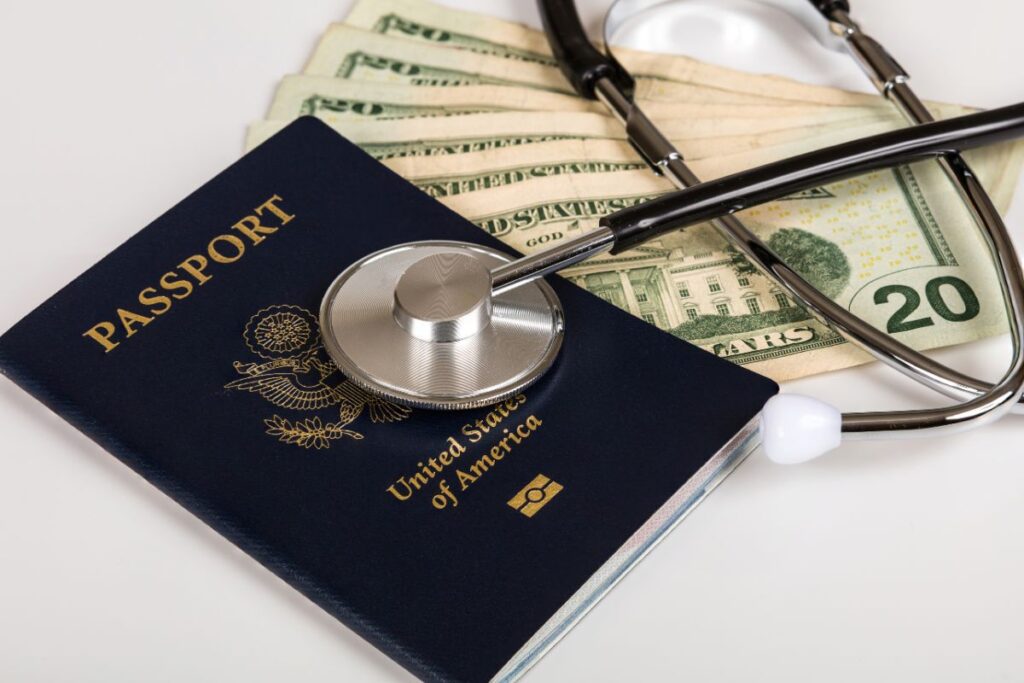 image of US passport with 6 $20 US dollar bills and a stethoscope